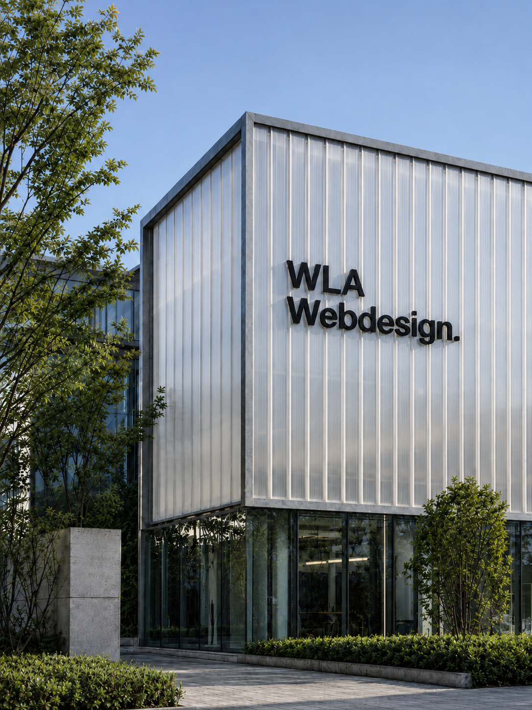 WLA Webdesign building exterior with black signage and landscaped entrance